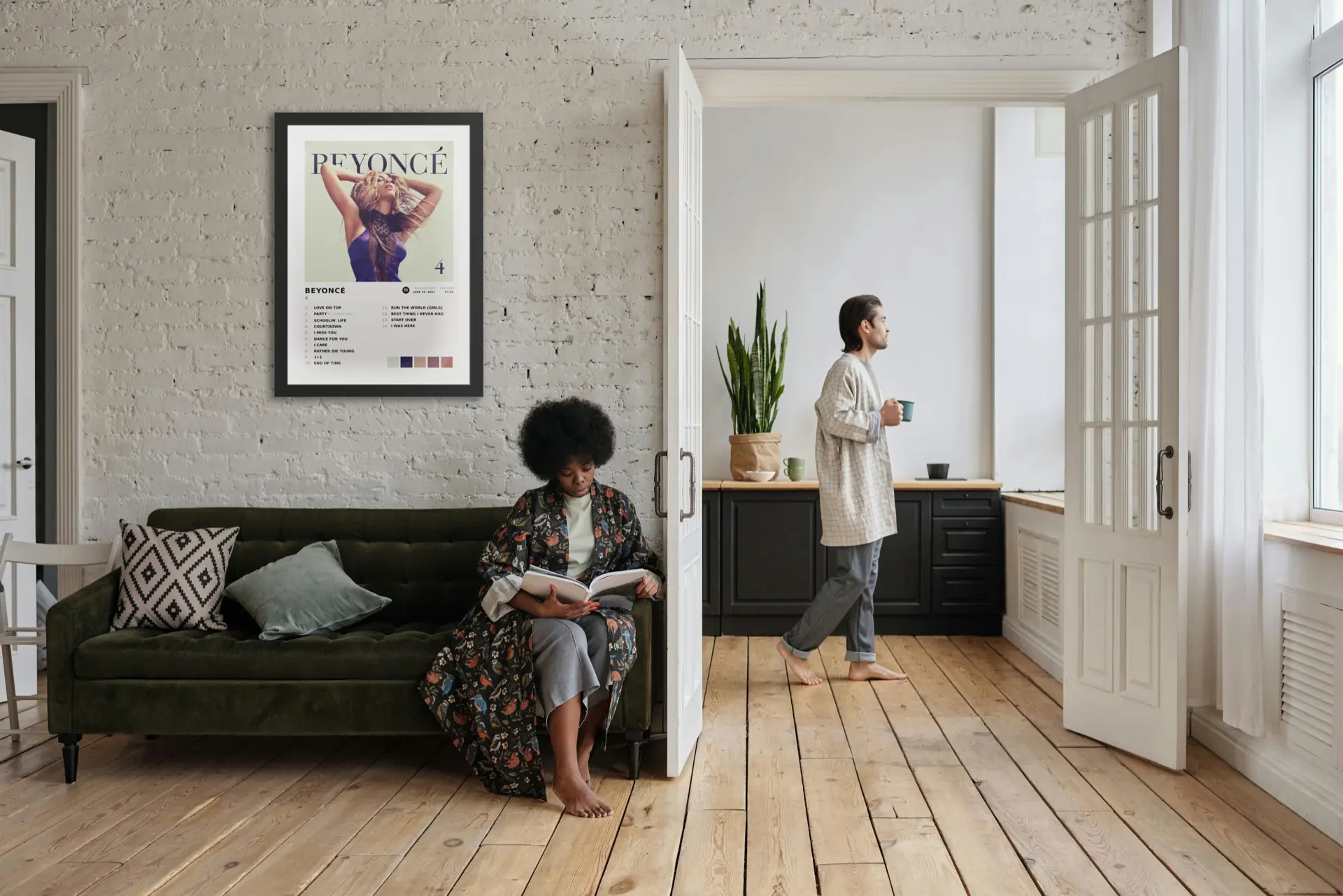 Beyoncé album art metal print on a living room wall with people relaxing at home